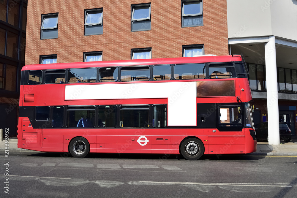Double Decker red bus is running on road in London