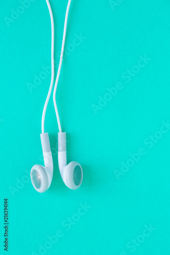 earbuds or earphones on green background