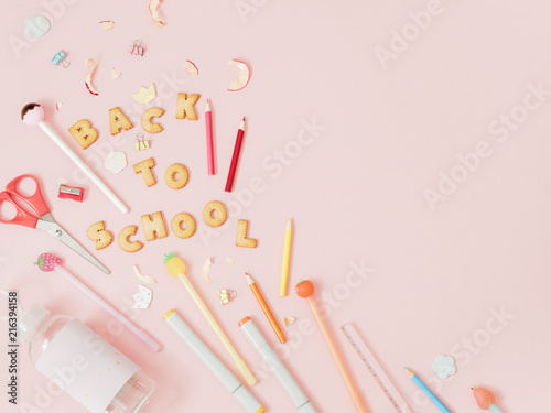 Colorful background with lettering Back to School made of cookies on pink pastel background, school concept