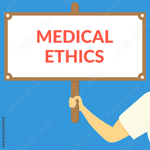 MEDICAL ETHICS. Hand holding wooden sign