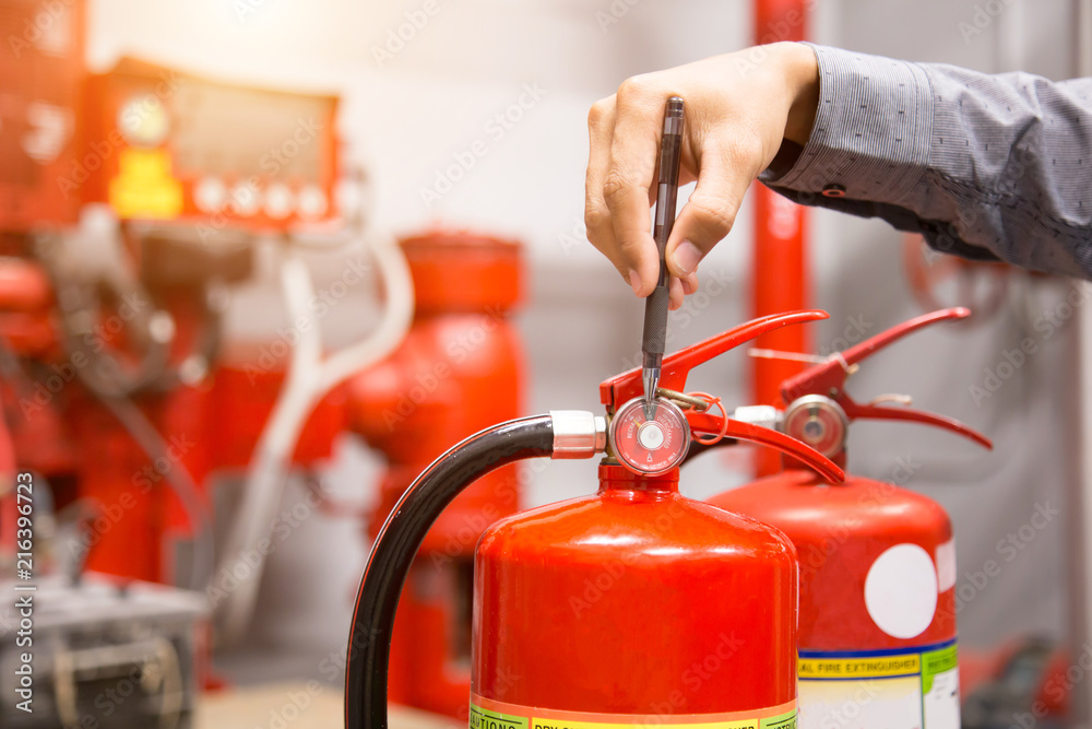 Engineer inspection Fire extinguisher in control room. Engineer inspection Fire extinguisher in control room.