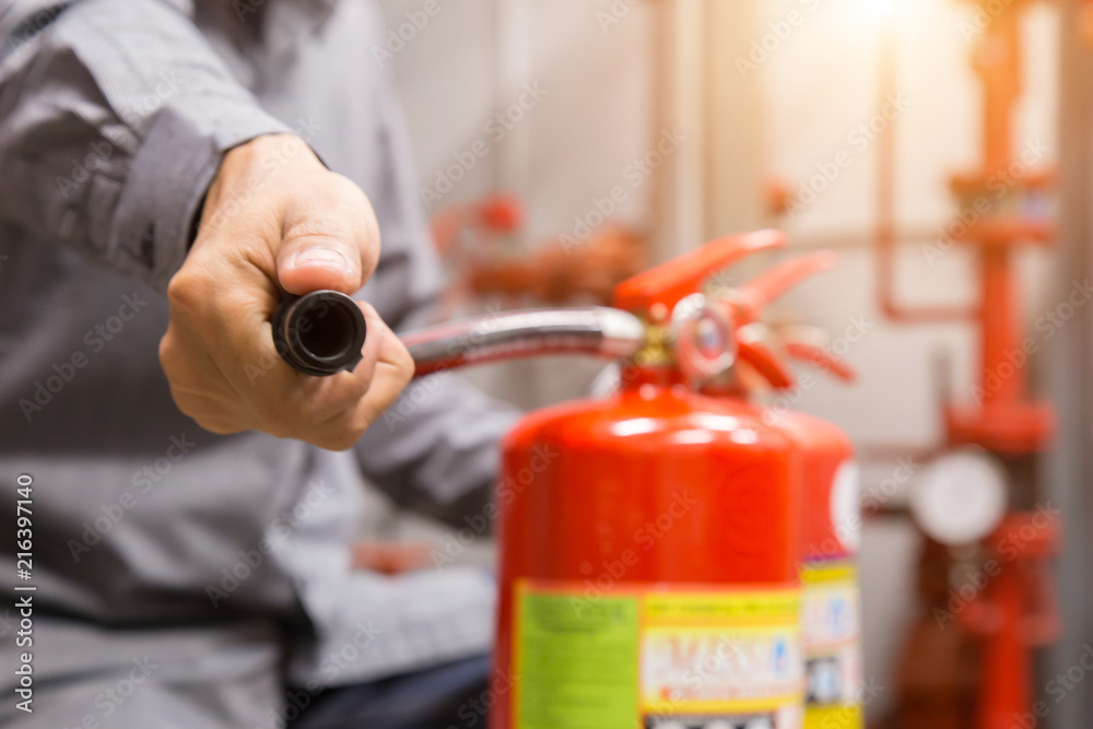 Naklejka premium Engineer inspection Fire extinguisher in control room.