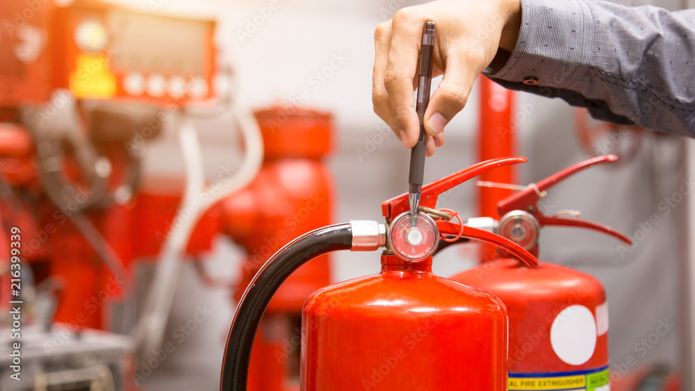 Engineer inspection Fire extinguisher in control room. Engineer inspection Fire extinguisher in control room.