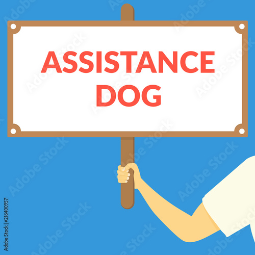 ASSISTANCE DOG. Hand holding wooden sign