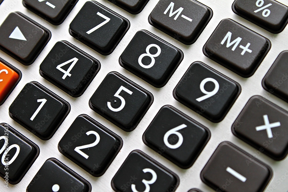 Business, finance, savings money, investment, taxes or accounting concept : Close up of black button calculator Business, finance, savings money, investment, taxes or accounting concept : Close up of black button calculator