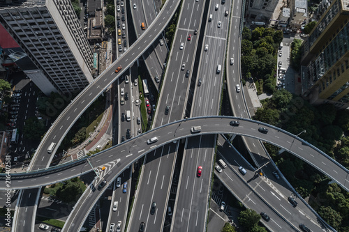 Aerial view of highway and overpass in city on sunny day