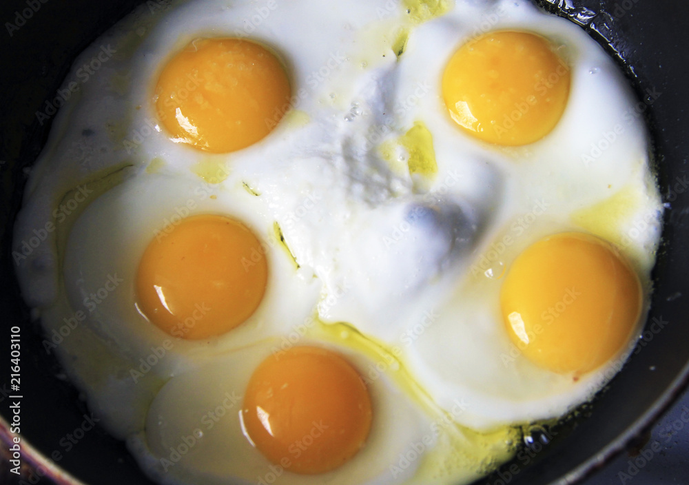 Roasted eggs on the black pan and dill over Roasted eggs on the black pan and dill over