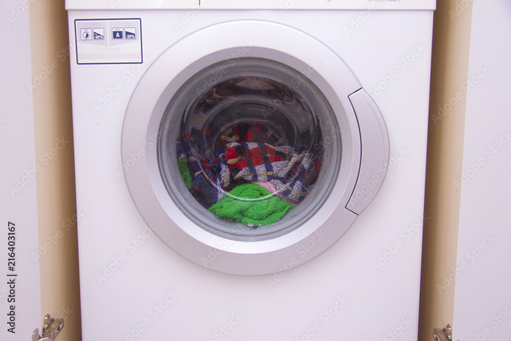 Front view of a washing machine drum during cleaning clothes Front view of a washing machine drum during cleaning clothes