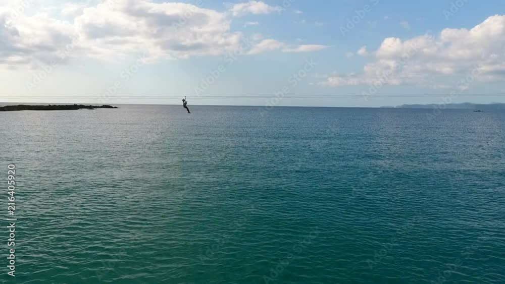 A Person Going Down a Zipline Over the Ocean in the Philippines, Drone Tracking Shot