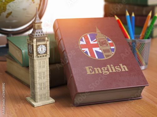 Studying and learn English concept. Book with flag of Great Britain and Big Ben tower on the table. photo