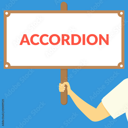 ACCORDION. Hand holding wooden sign