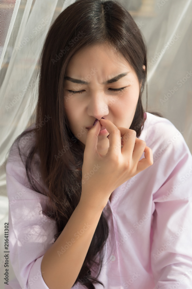 sick girl sniffle with runny nose; sick woman suffering from cold, flu, runny nose, trying to clear her nose; woman personal health care, sinus pain, sickness concept; asian young adult woman model sick girl sniffle with runny nose; sick woman suffering from cold, flu, runny nose, trying to clear her nose; woman personal health care, sinus pain, sickness concept; asian young adult woman model