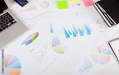Photo diagrams graphs and numerals in the table on the paper