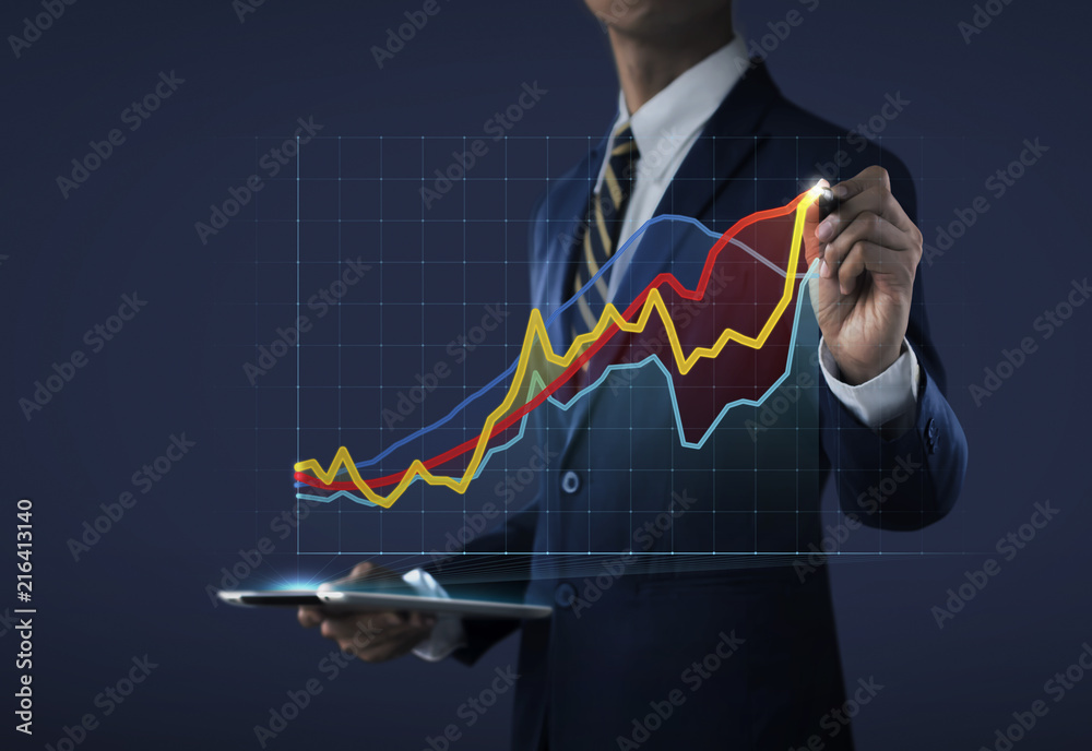 Business growth, progress or success concept. Businessman is drawing a growing 3d virtual hologram graph on dark tone background. Business growth, progress or success concept. Businessman is drawing a growing 3d virtual hologram graph on dark tone background.