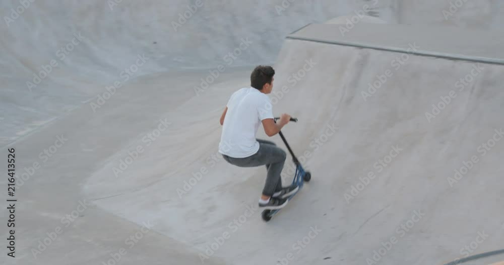 Scooter rider in skatepark slowmotion 4K