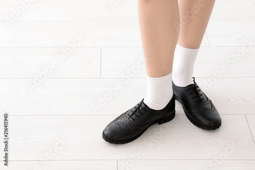 Girl in stylish school uniform indoors, focus on legs