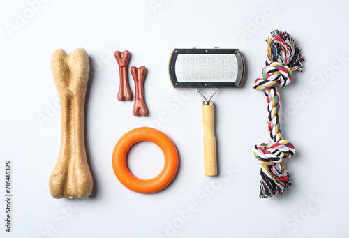 Fototapeta Naklejka Na Ścianę i Meble -  Flat lay composition with accessories for dog on light background. Pet care