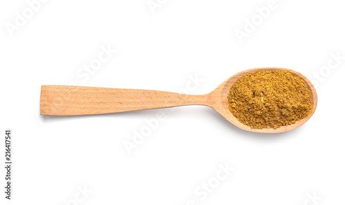Wooden spoon with curry on white background. Different spices