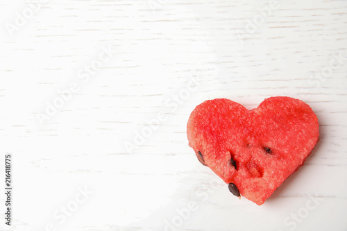 heart shaped watermelon slice on white wooden background  top view