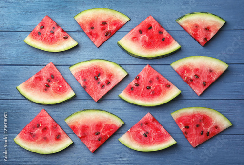 Flat lay composition with watermelon slices on wooden background