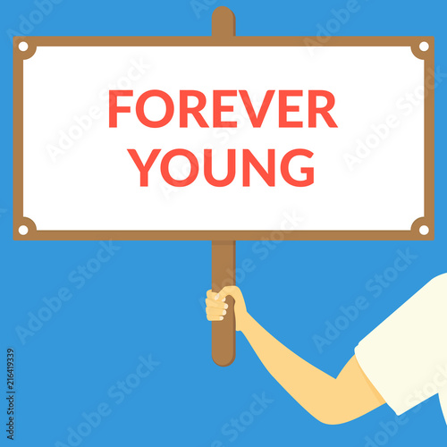 FOREVER YOUNG. Hand holding wooden sign