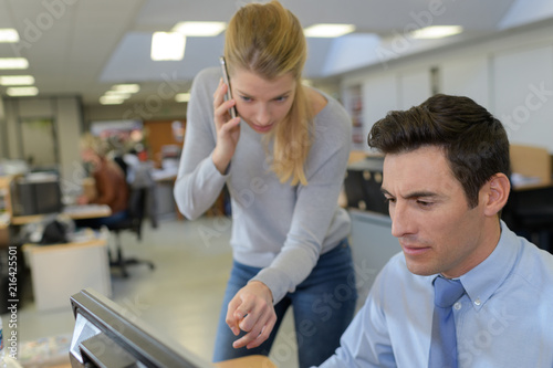 woman assisting male computer clerk