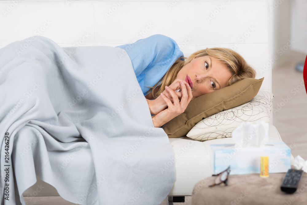 sick mature european woman sitting on couch at home sick mature european woman sitting on couch at home