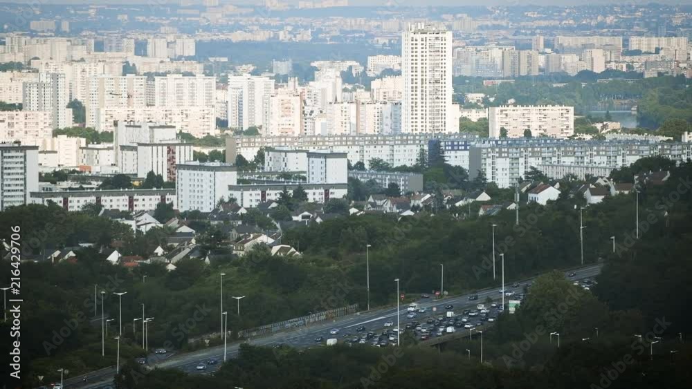 Heavy traffic jam over the A15 highway autoroute peripherique with the city of Sannois, Paris in the background - aerial still drone news report Heavy traffic jam over the A15 highway autoroute peripherique with the city of Sannois, Paris in the background - aerial still drone news report
