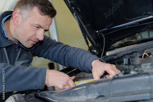 car mechanic uses battery