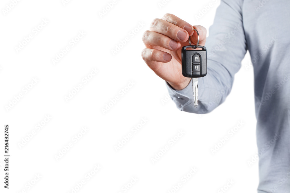 Fototapeta premium Male hand holding car key, isolated on white background