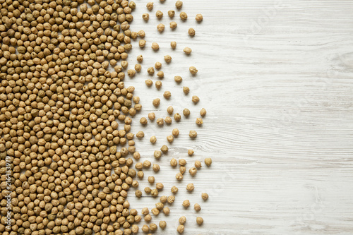 Dried chickpeas on white background, top view. Copy space.