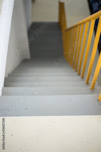 Wooden staircase with yellow railing