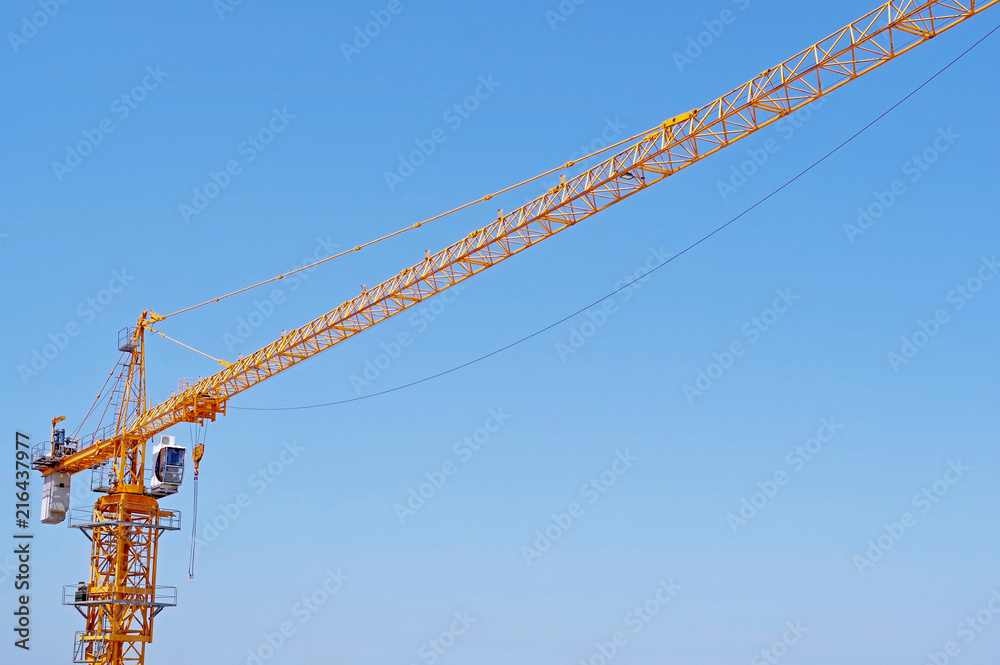 yellow construction crane tower on background of blue sky yellow construction crane tower on background of blue sky