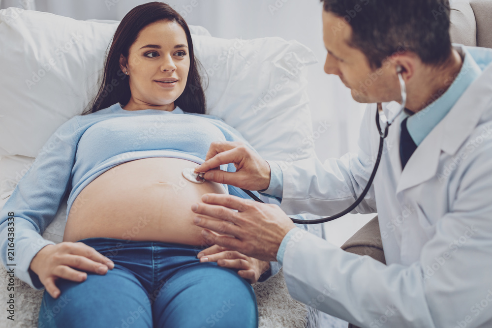 Fototapeta premium Keep calm. Pretty female person expressing positivity while demonstrating her tummy