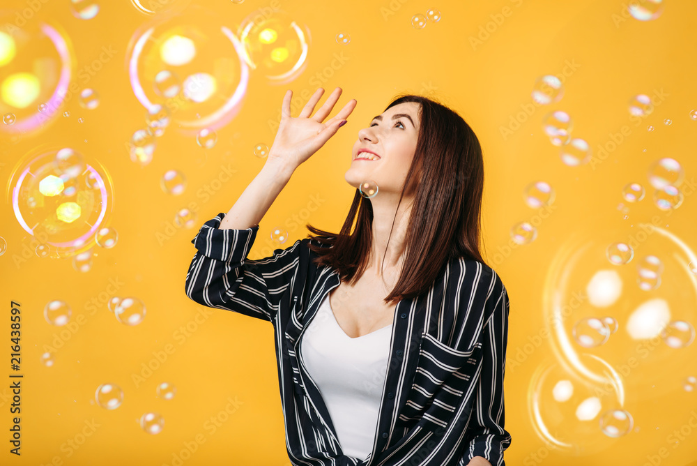 Pretty woman catches soap bubble