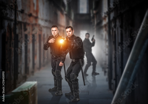 Special force soldiers with guns and lantern