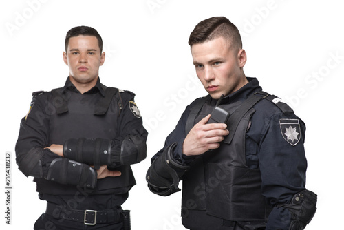 Cops in uniform and body armor on white background