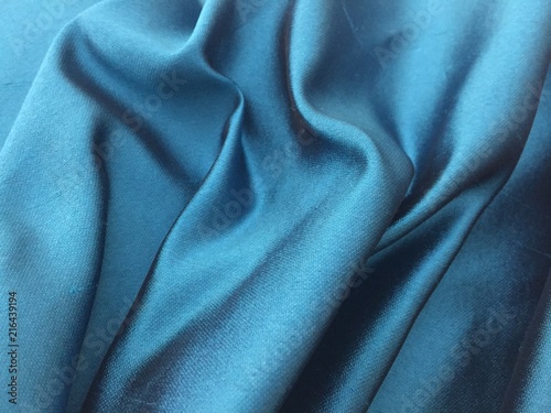 Woven texture of silk fabric or yarn turquois color changeable for background. Draped folded satin.