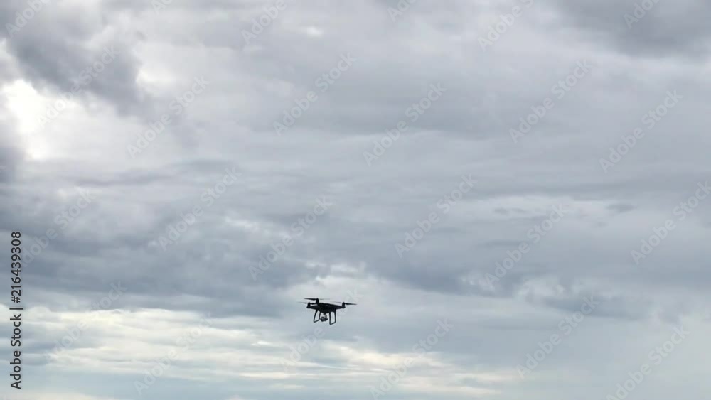 Drone flying and floating above the sea. Cloudy dark sky over sea with small waves. Beach with solid rock. Drone flying and floating above the sea. Cloudy dark sky over sea with small waves. Beach with solid rock.