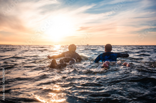 Sun surfer. A man is walking with a surf in his hands across the sea shore.