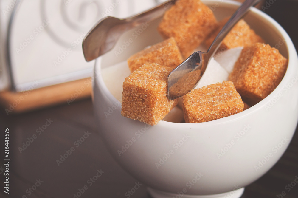 Sugar Bowl with cubes of white cane sugar, sugar-tongs and napkins.  Atmosphere and table appointments in the city cafe Stock Photo | Adobe Stock