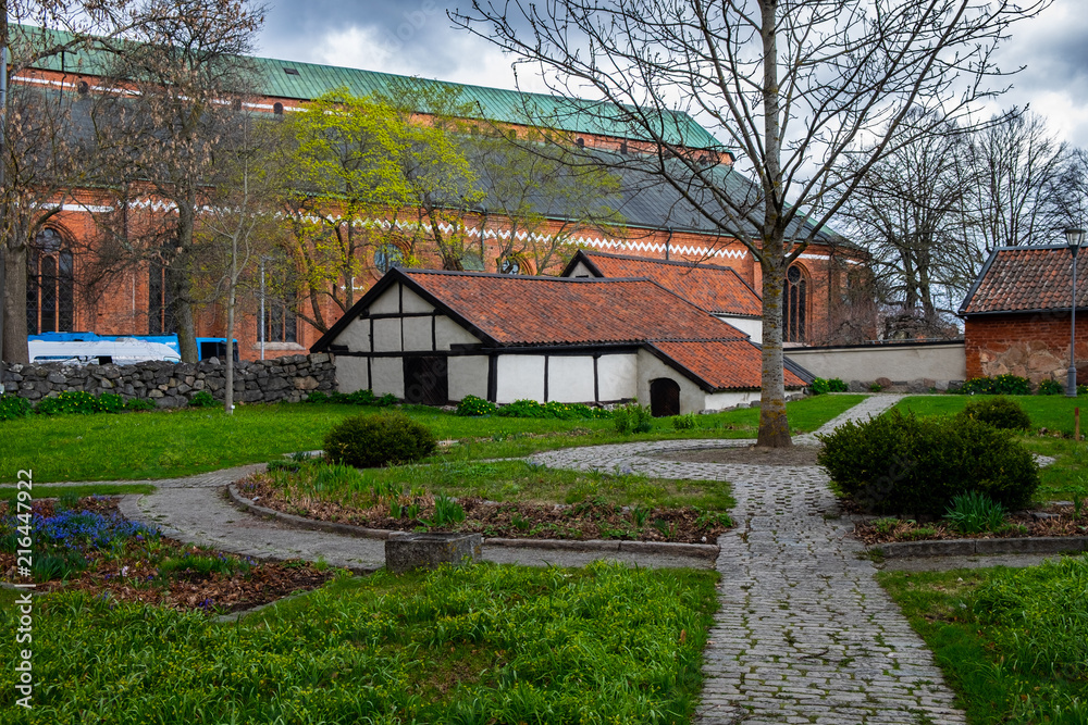 Old brick buildings and a small park near the cathedral in the center of Swedish town Vasteras shot on a cloudy and rainy spring day Old brick buildings and a small park near the cathedral in the center of Swedish town Vasteras shot on a cloudy and rainy spring day