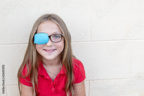 Fototapeta .Child in glasses with Occluder. Ortopad Girls Eye Patches nozzle for glasses fo