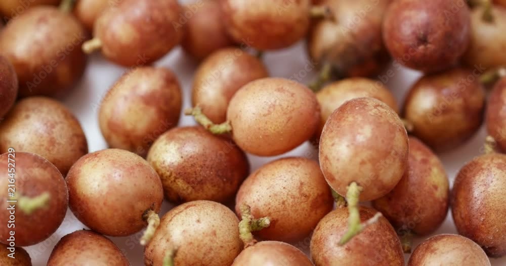 Clausena wampi fruit in rotation Clausena wampi fruit in rotation