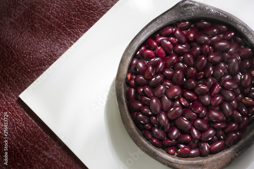 red cargamanto bean in clay bowl on white background photo