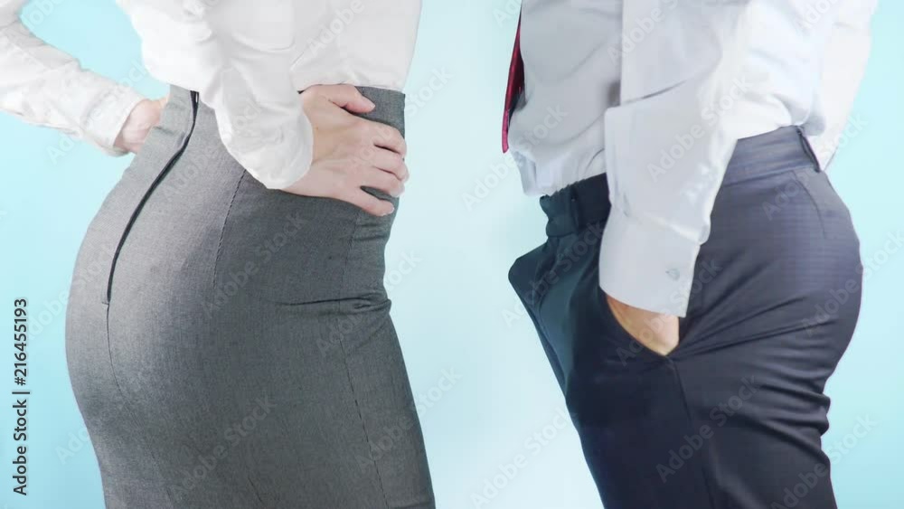 4K. Slow motion. Close-up. Colorful background. A businessman and a businesswoman are standing next to each other. A man is giving signs of attention to a woman.