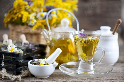 Cup of herbal tea with wild flowers and various herbs 