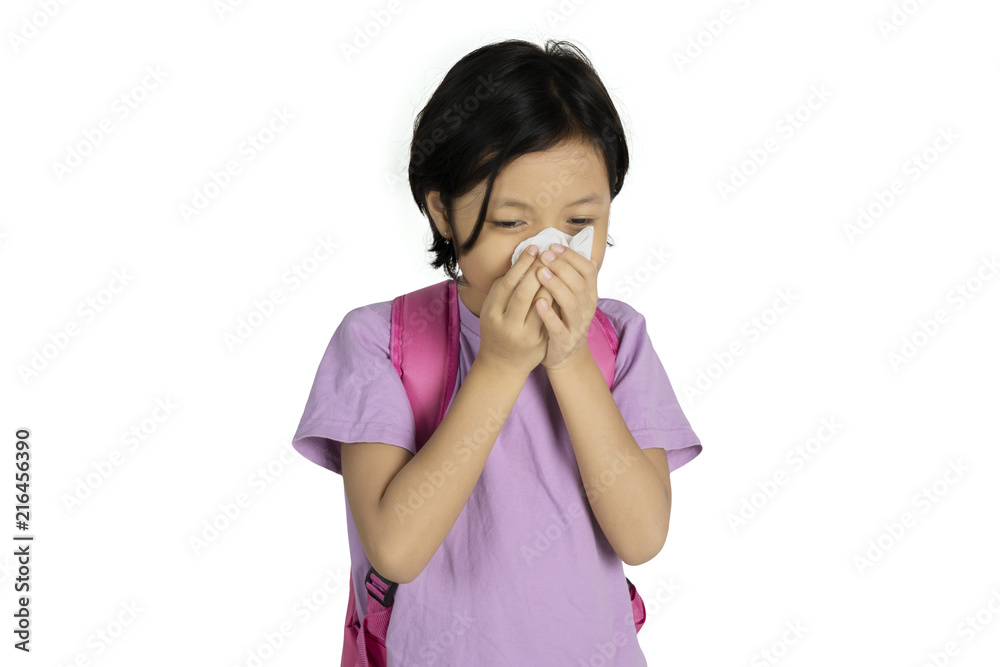 Asian schoolgirl wiping her nose with a tissue Asian schoolgirl wiping her nose with a tissue