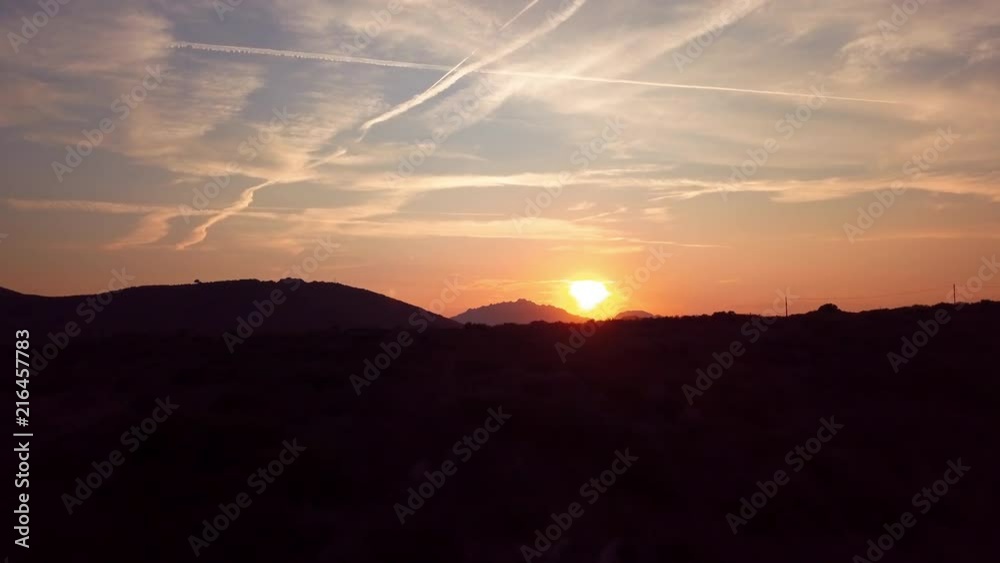 Video from above, aerial view of an amazing sunset behind some hills and a coast bathed by the Mediterranean Sea in Sardinia, Italy. Video from above, aerial view of an amazing sunset behind some hills and a coast bathed by the Mediterranean Sea in Sardinia, Italy.
