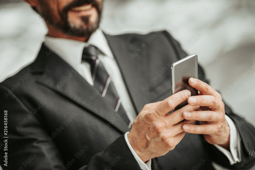 Happy unshaven male worker sending message on mobile. Satisfied male using gadget concept Happy unshaven male worker sending message on mobile. Satisfied male using gadget concept